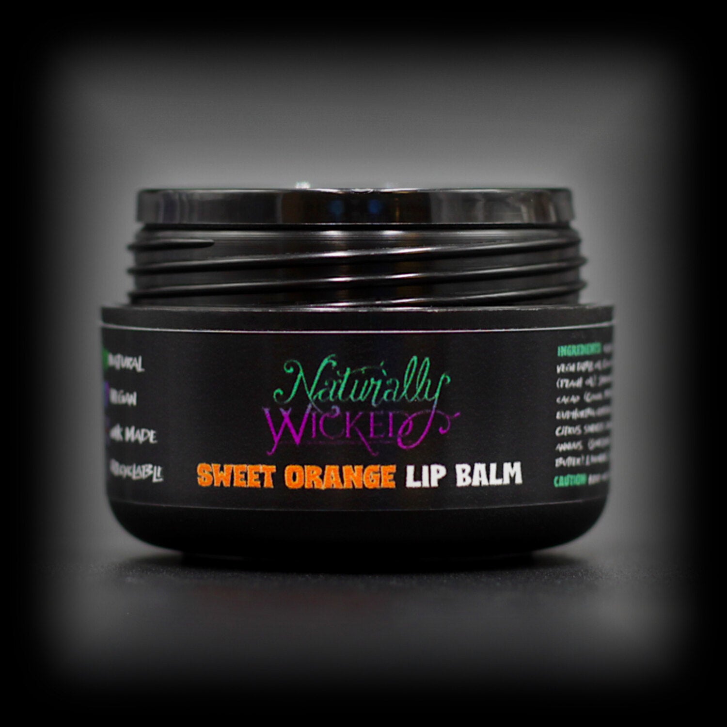Naturally Wicked Sweet Orange Lip Balm With Lid Removed, Exposing Inner Luxury Sealing Shive