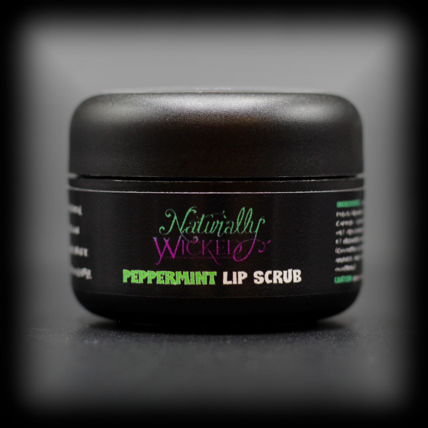 Naturally Wicked Peppermint Lip Scrub In Luxury Black Container On Dark Background