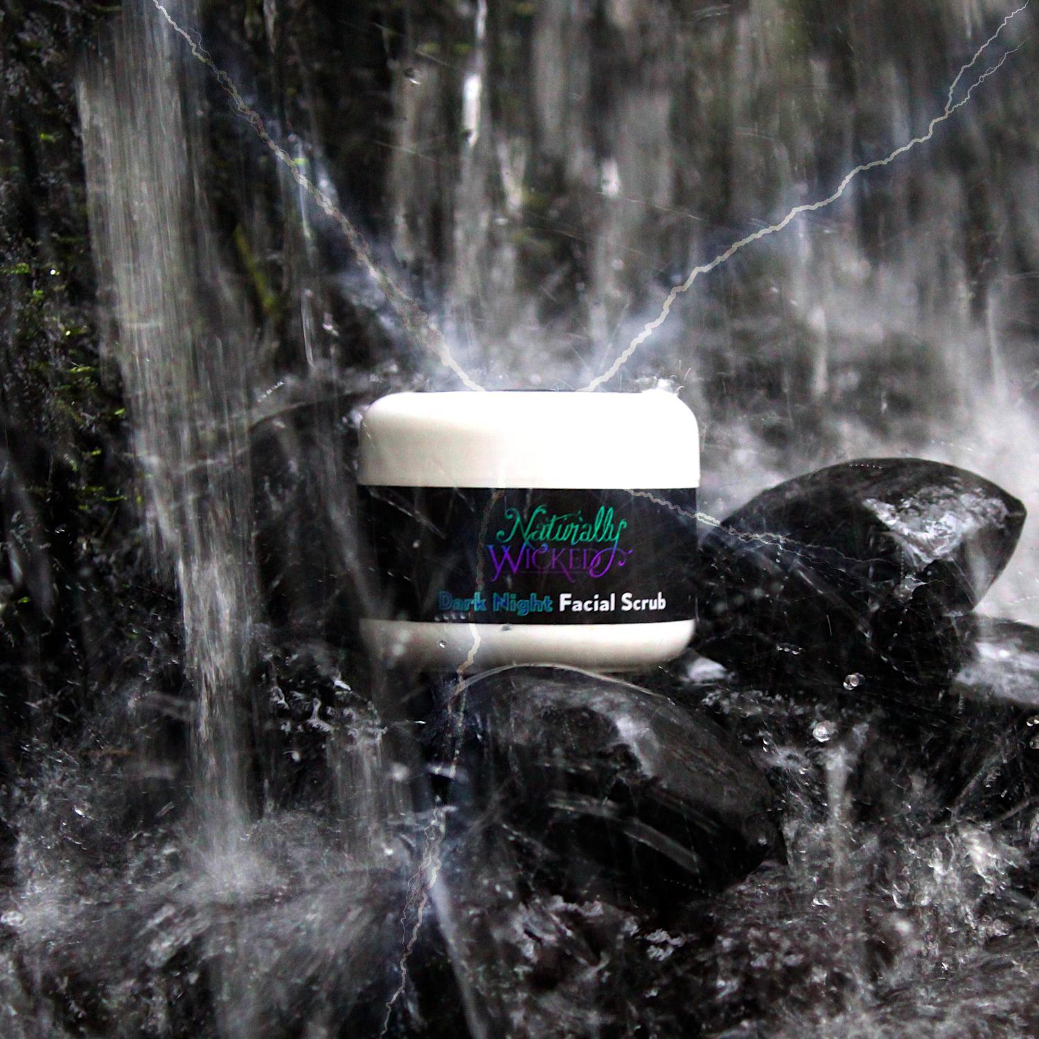 Naturally Wicked Dark Night Facial Scrub Surrounded By Charcoal In Waterfall With Electrical Charge