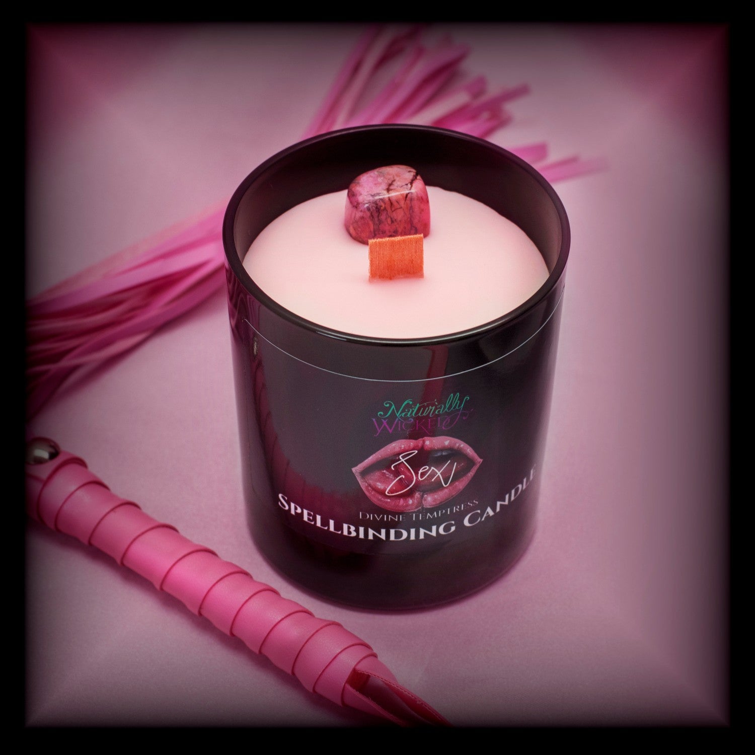 A Unique And Sexy Gift.  A Scenic View Of The Perfect Sexy Spell Candle Next To Pink Seductive Whips. Naturally Wicked Spellbinding Sex Candle Proudly Presents It's Dark Black Gloss Label With A Pair Of Juicy Wet Pink Lips And Tongues Kissing Seductively On The Front. The Candle Features Plant-based Smooth Pink Wax, A Wood Wick And A Beautiful Rhodonite Crystal.