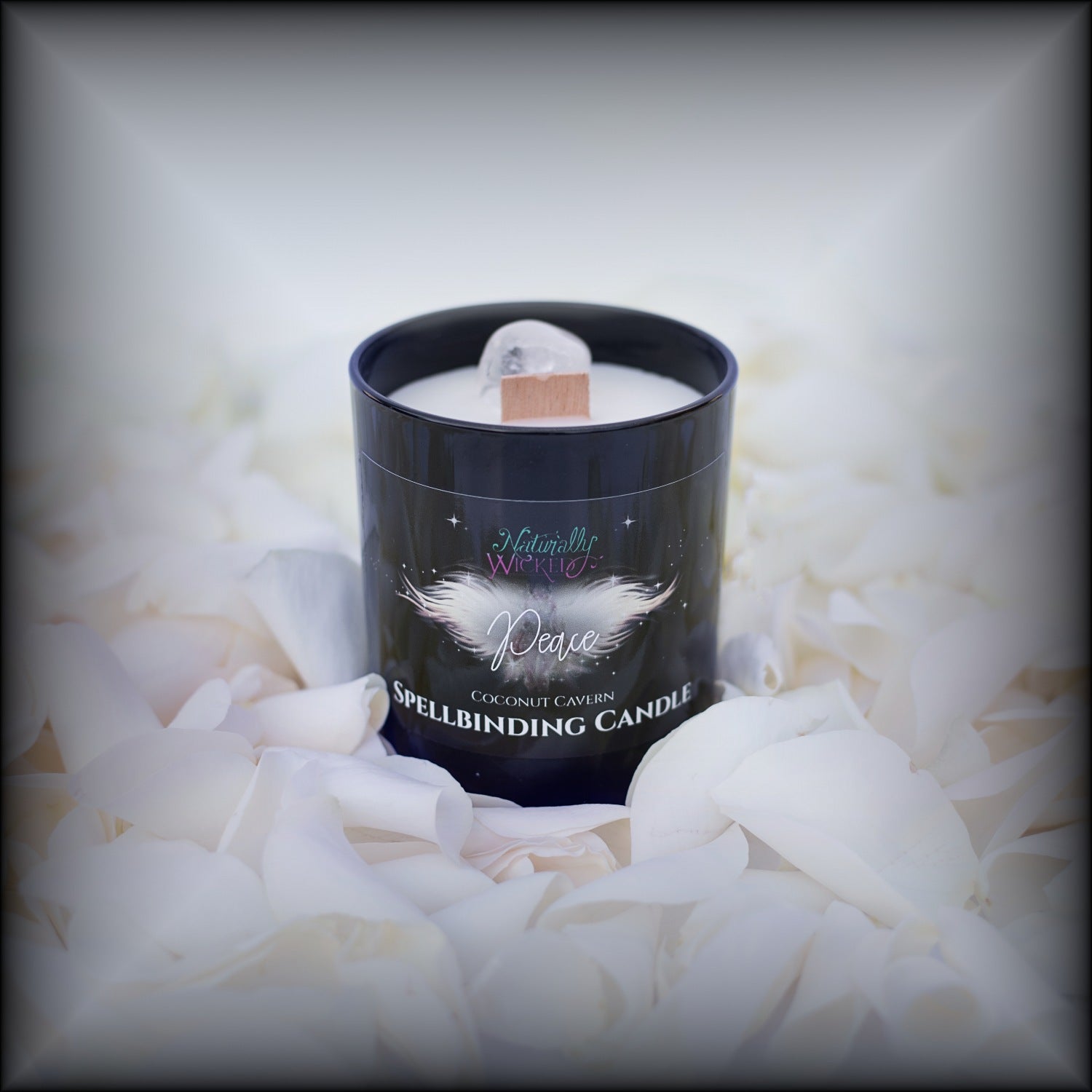 A Scenic View Of The Perfect Spell Candle Surrounded By Pure White Rose Petals. Naturally Wicked Spellbinding Peace Candle Proudly Presents It's Dark Black Gloss Label With A Beautiful Angel Of Peace On The Front. The Candle Features Plant-based Smooth Pure White Wax, A Wood Wick And A Beautiful Clear Quartz Crystal.