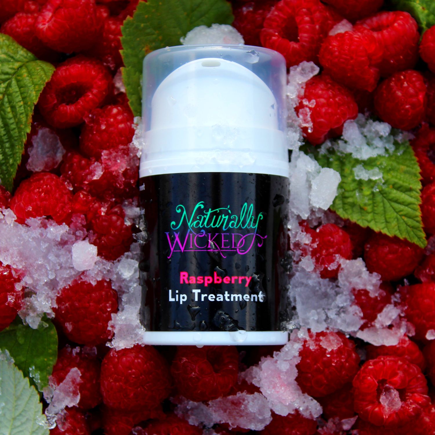 Raspberry Lip Treatment 50ml Lay In A Pile Of Ice & Bright Red Luscious Raspberries With Green Raspberry Leaves