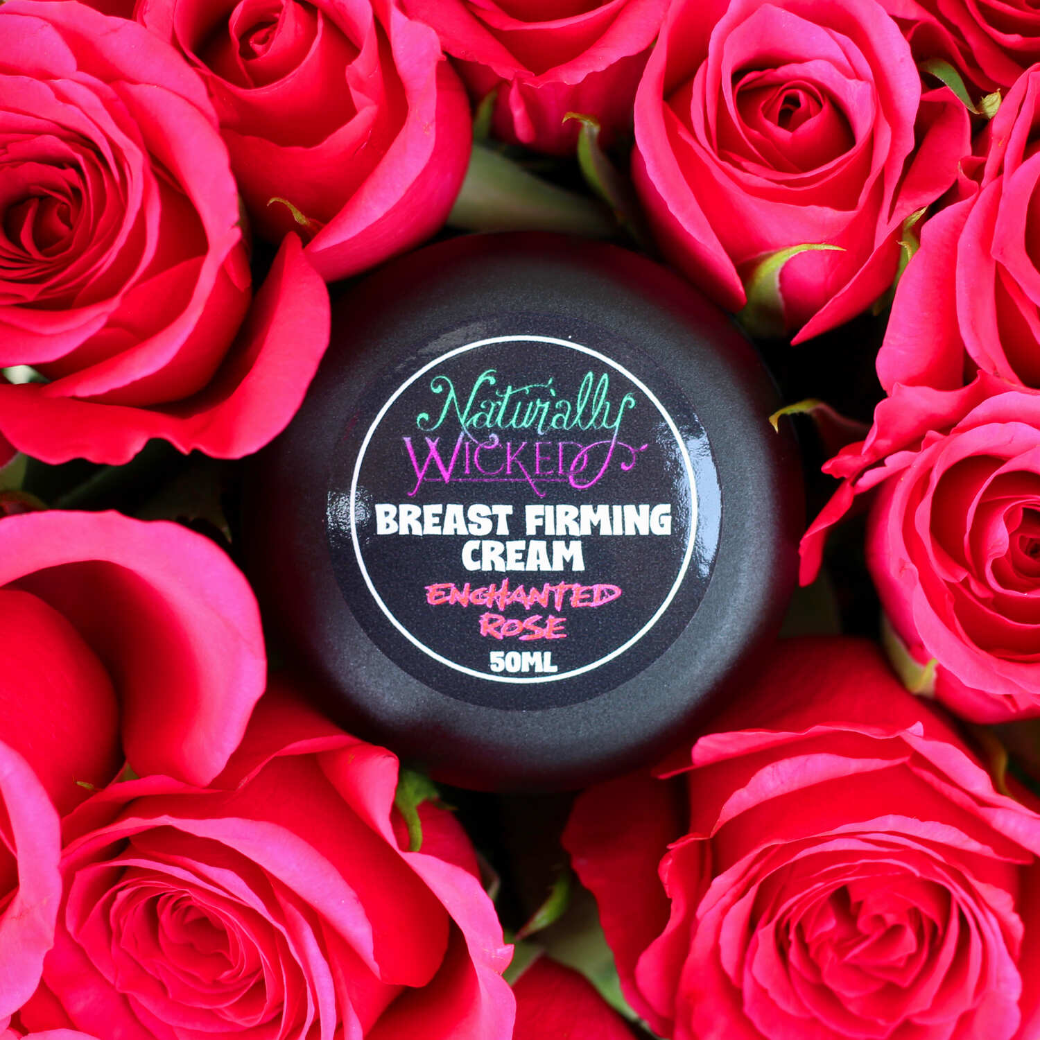 Naturally Wicked Enchanted Rose Breast Firming Cream Amongst A Trove Of Beautiful Pink Roses
