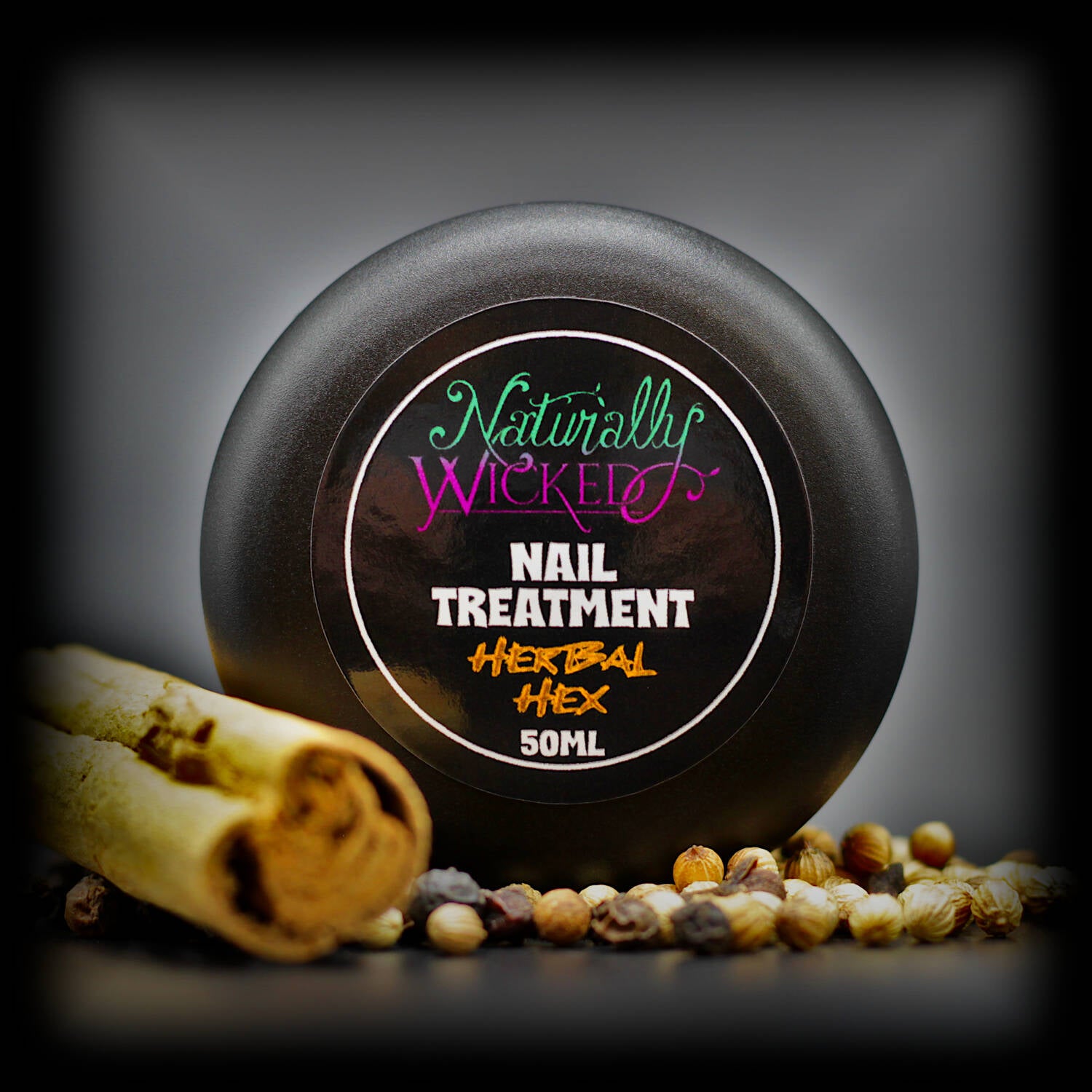 Naturally Wicked Herbal Hex Nail Treatment Lid Surrounded By Rich Dry Nail Restoring Herbs