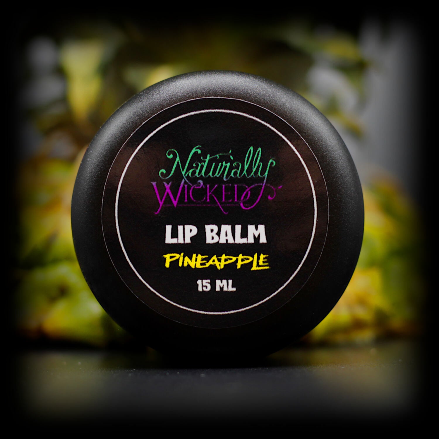 Naturally Wicked Pineapple Lip Balm Top Beside Fresh Pineapple Top