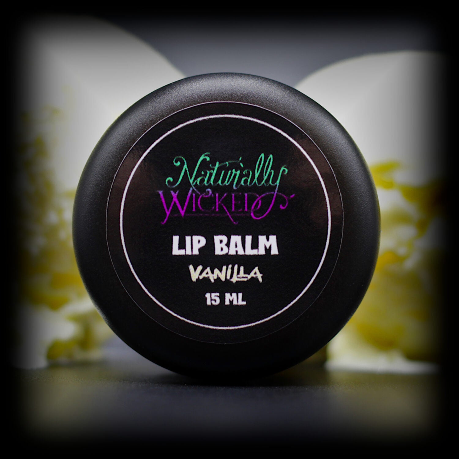 Naturally Wicked Vanilla Lip Balm Lid Lay Before Scoops Of Vanilla Ice Cream