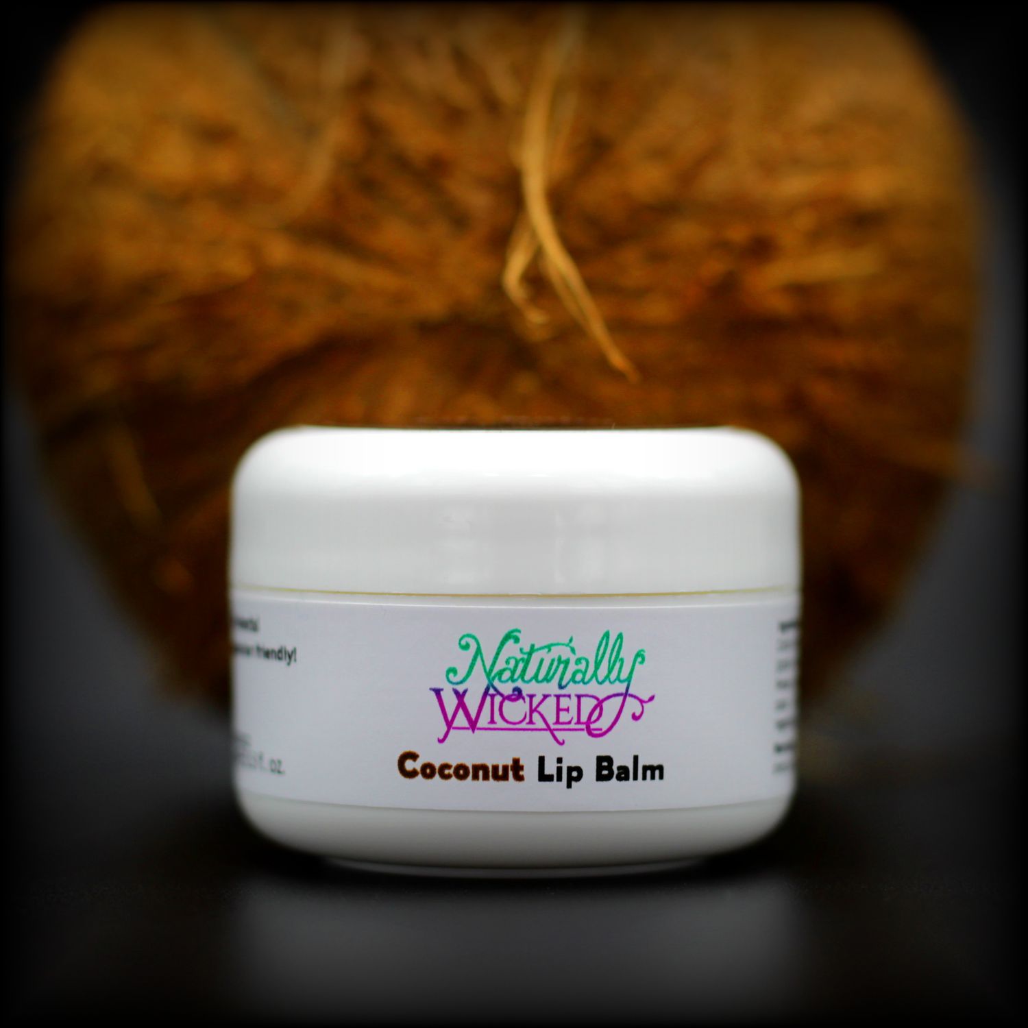 Naturally Wicked Protective Coconut Lip Balm With Brown Coconut Husk Behind