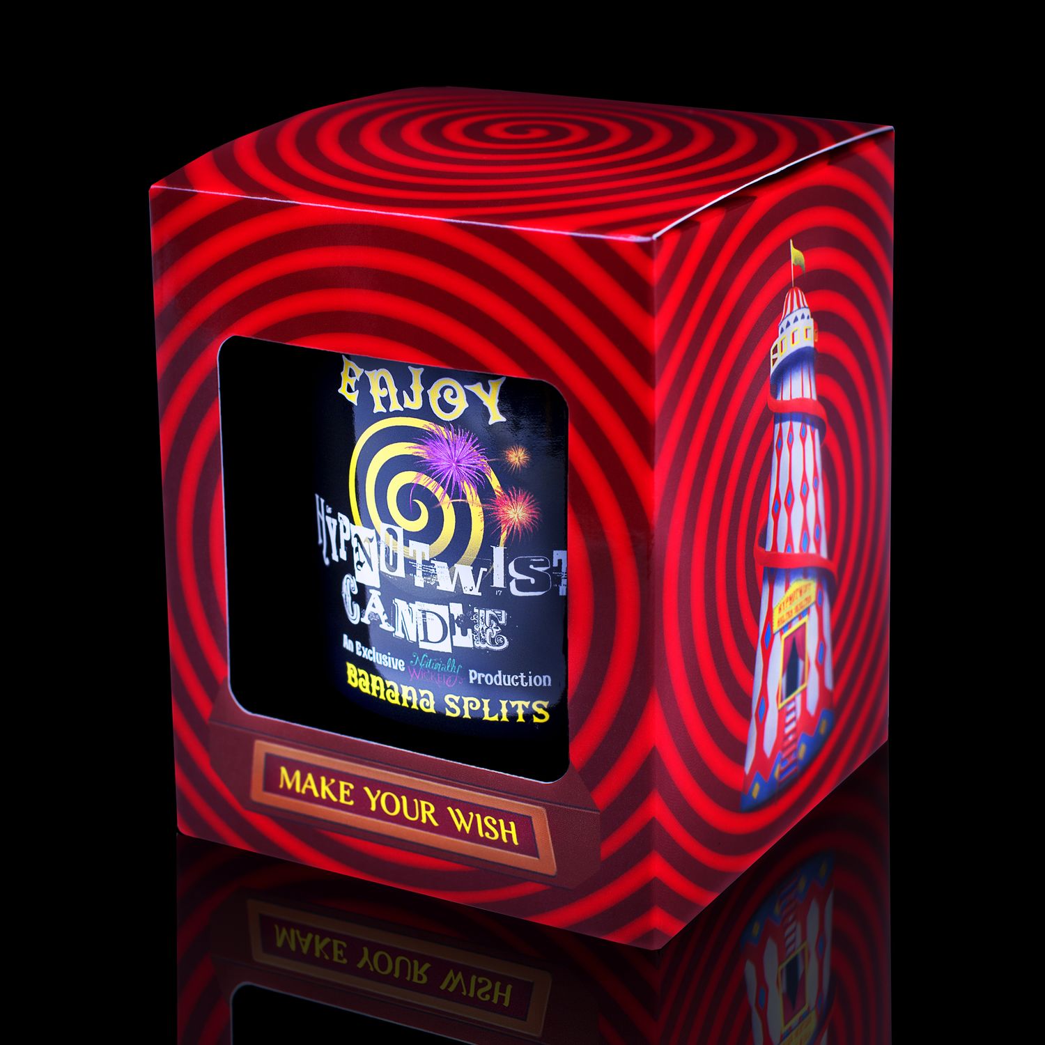 Side View Of The Naturally Wicked Hypnotwist Enjoy Candle, Plant-based Soy Yellow Wax Scented With Banana Splits, Including A Yellow Jade Crystal Spinning Top, Mirrored Lid & Red Circus Hypnotic Gift Box