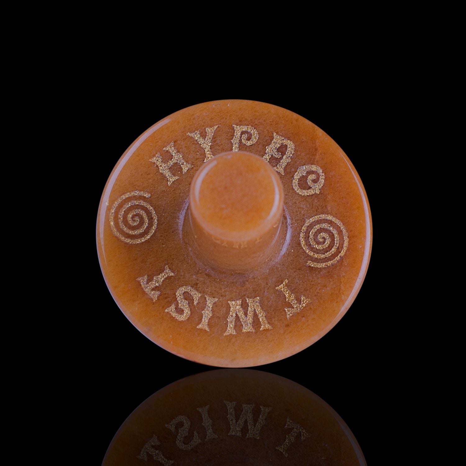 Front View Of The Naturally Wicked Exclusive Hypnotwister. A Yellow Jade Crystal Spinning Top Engraved With Hypno Twist