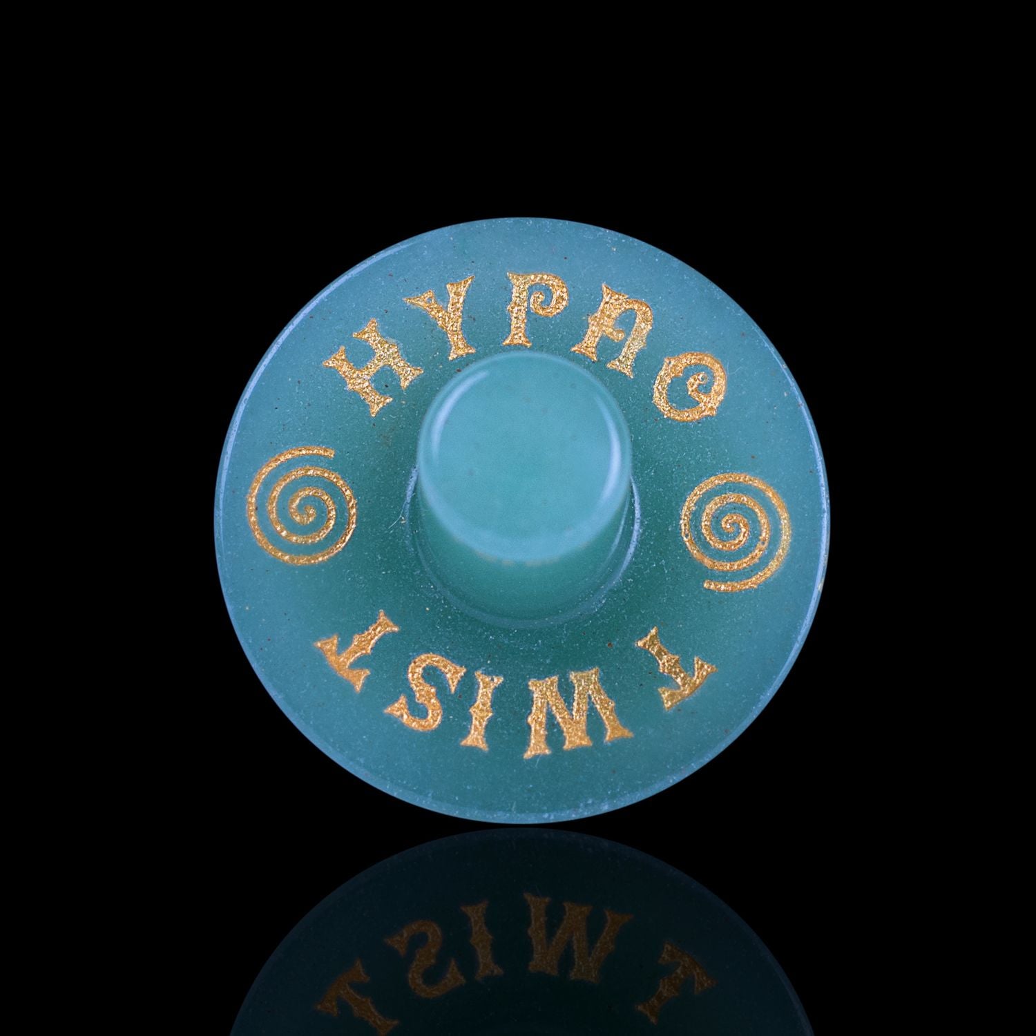Front View Of The Naturally Wicked Exclusive Hypnotwister. A Green Aventurine Crystal Spinning Top Engraved With Hypno Twist