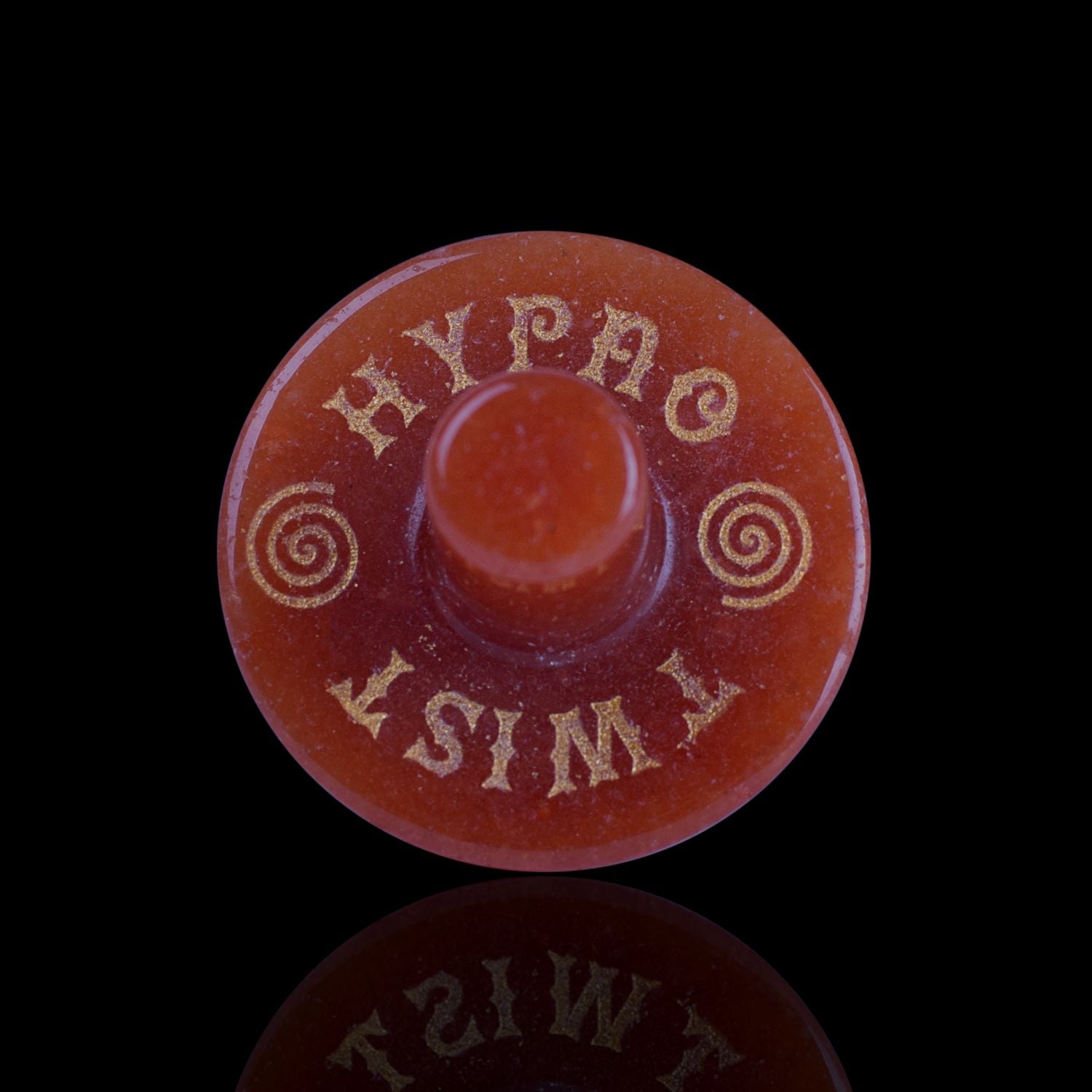 Front View Of The Naturally Wicked Exclusive Hypnotwister. An Orange Aventurine Crystal Spinning Top Engraved With Hypno Twist