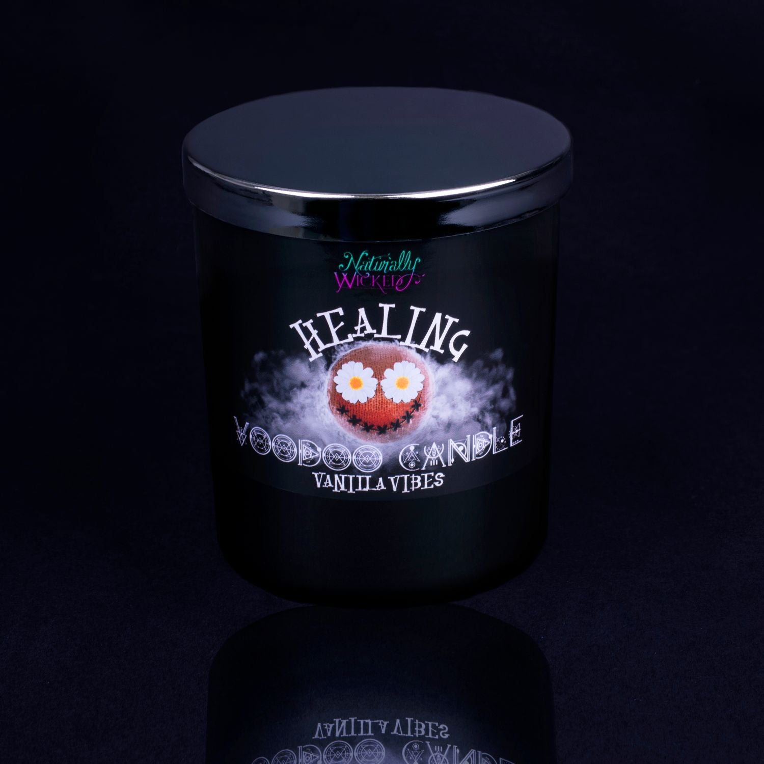Naturally Wicked Voodoo Healing Spell Candle With Mirror Finished Exquisite Lid In Place. Featuring A Black Gloss Label, A Voodoo Doll Design And Vanilla Vibes Scent.
