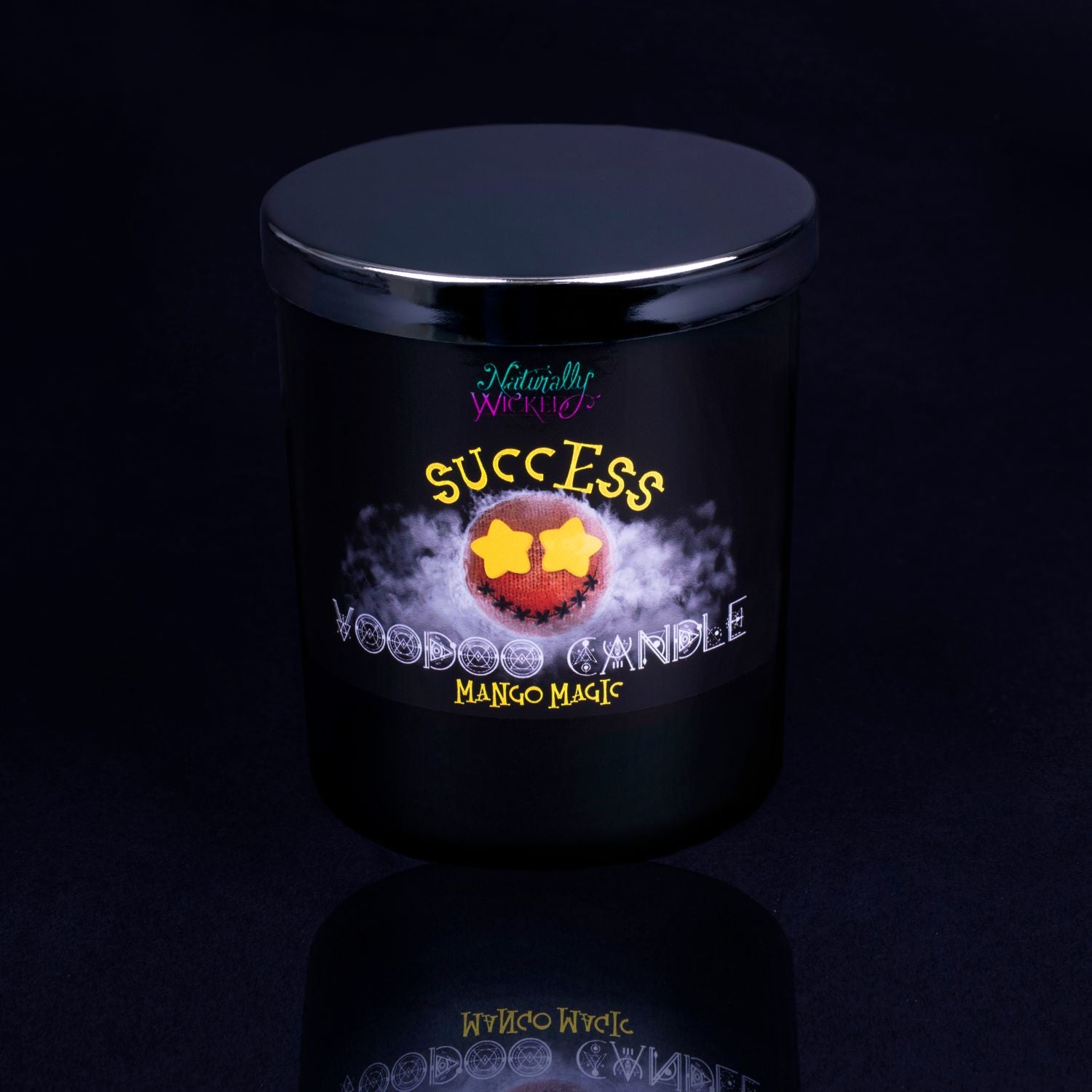 Naturally Wicked Voodoo Success Spell Candle With Mirror Finished Exquisite Lid In Place. Featuring A Black Gloss Label, A Voodoo Doll Design And Mango Magic Scent.