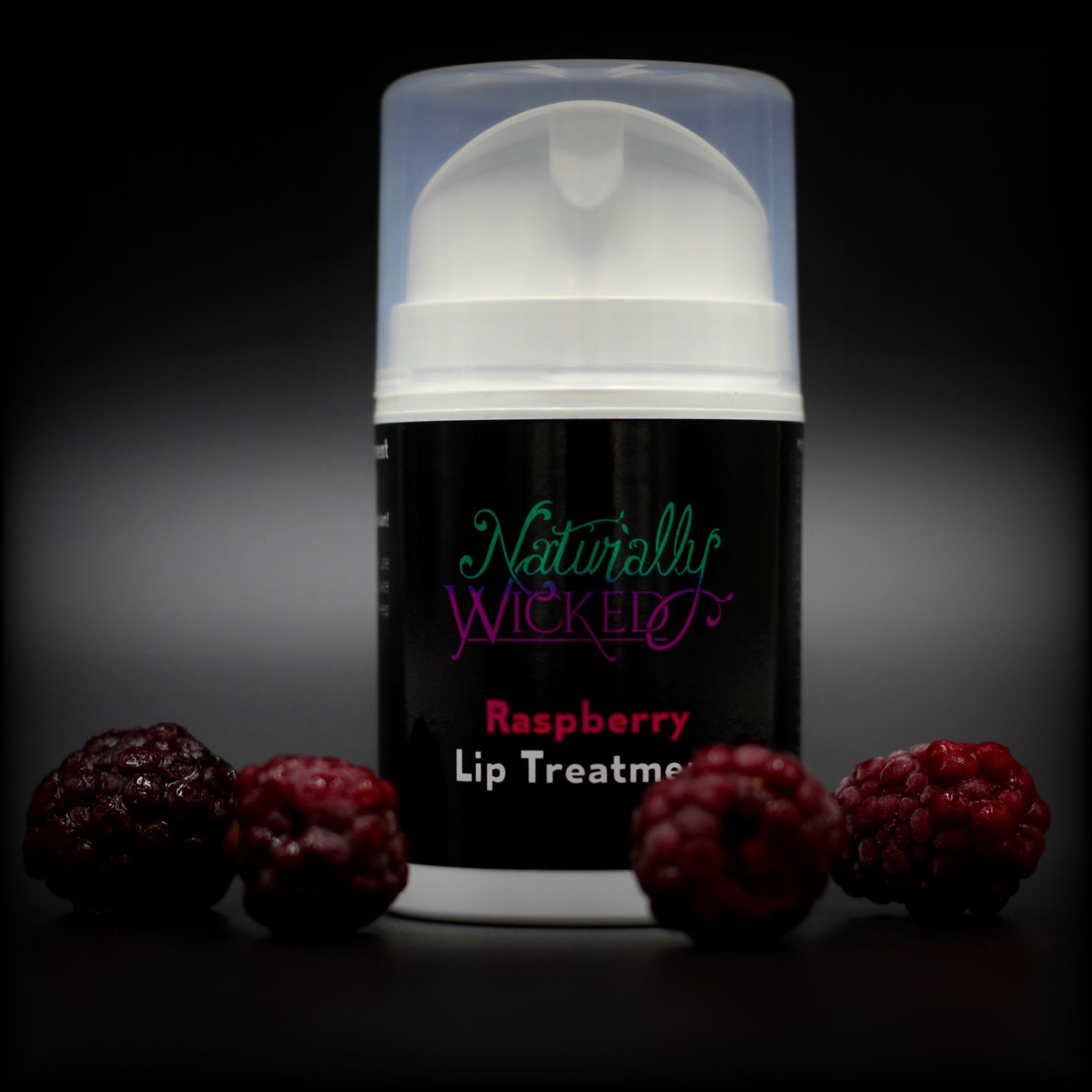Naturally Wicked Raspberry Lip Treatment Surrounded By Dark Red Luscious Raspberries